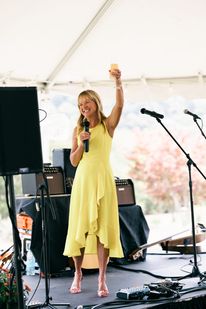 mom toasting on stage