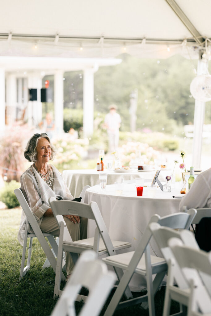 woman sitting at table smiling