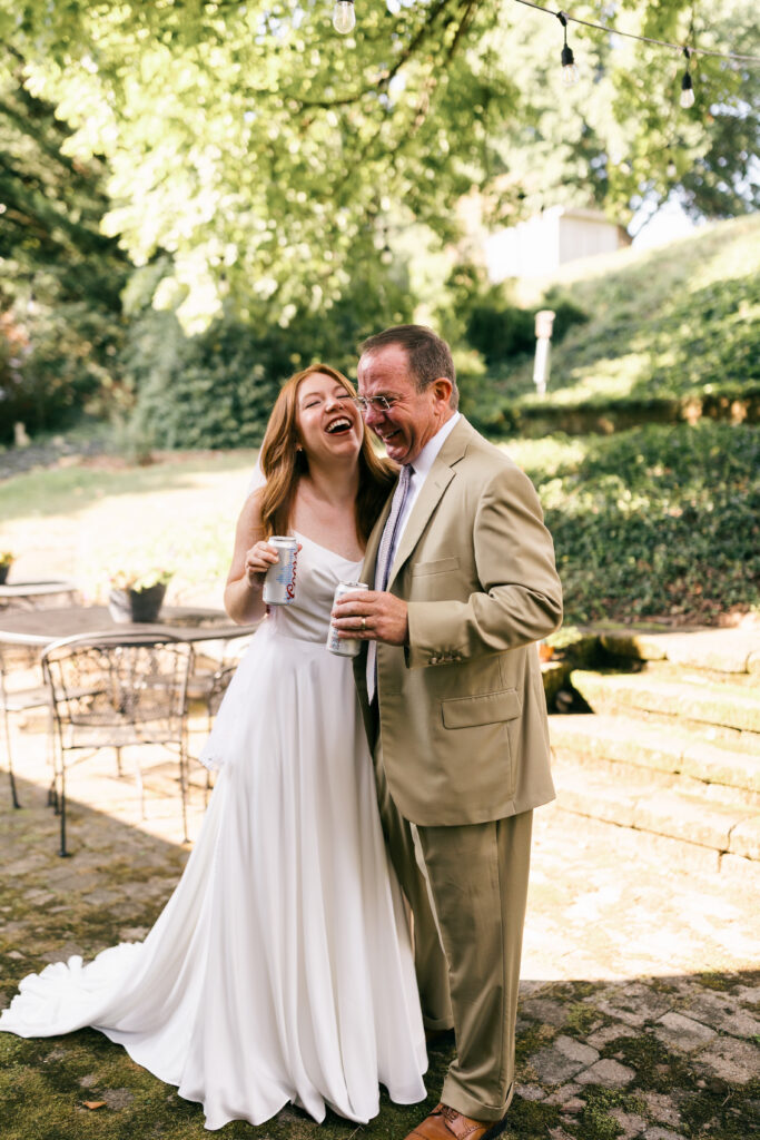bride and dad laughing and hugging