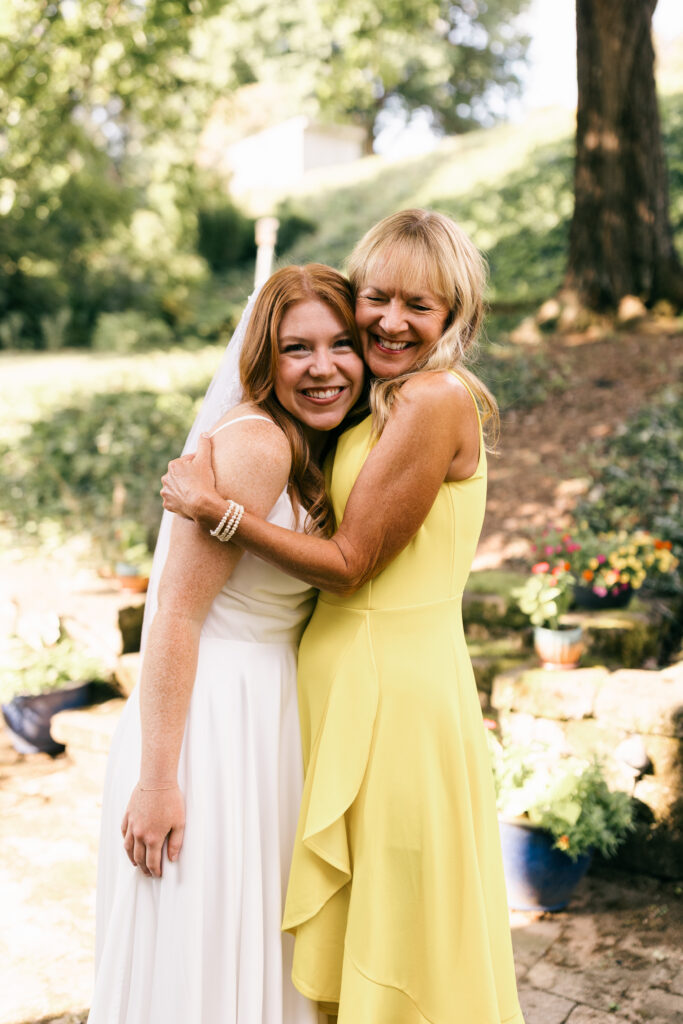 bride and mom hugging