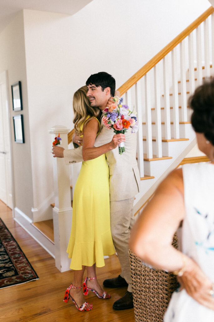 groom and bride's mom hugging in the kitchen