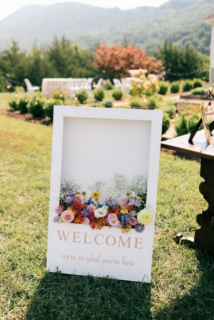 wedding welcome sign featuring flowers inside