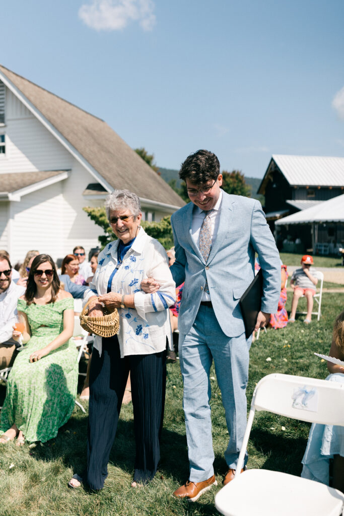 a grandma walking down the aisle at a wedding ceremony