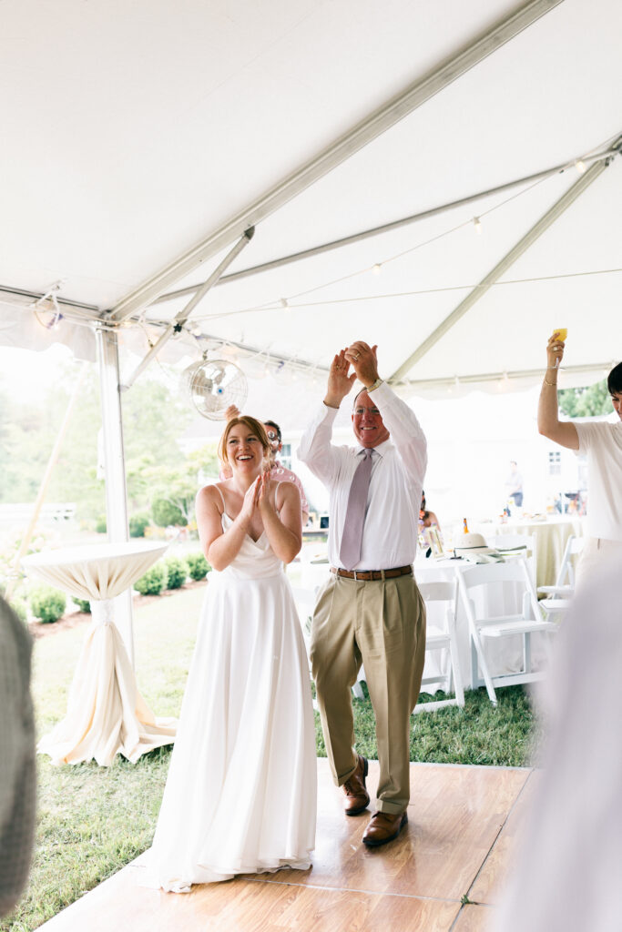bride and her dad clapping