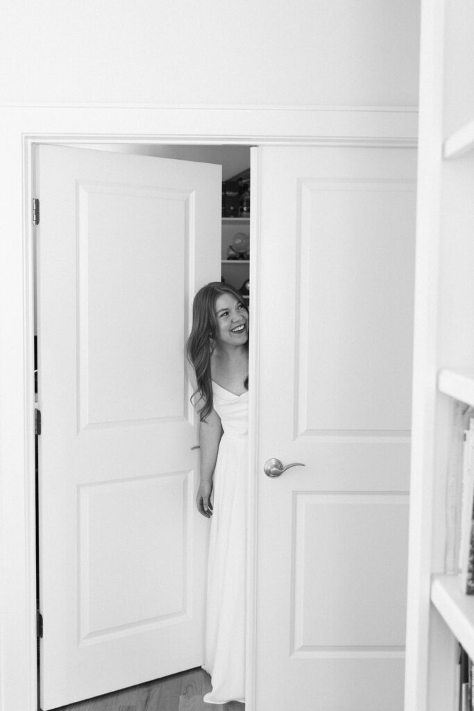 bride looking out the door of a room