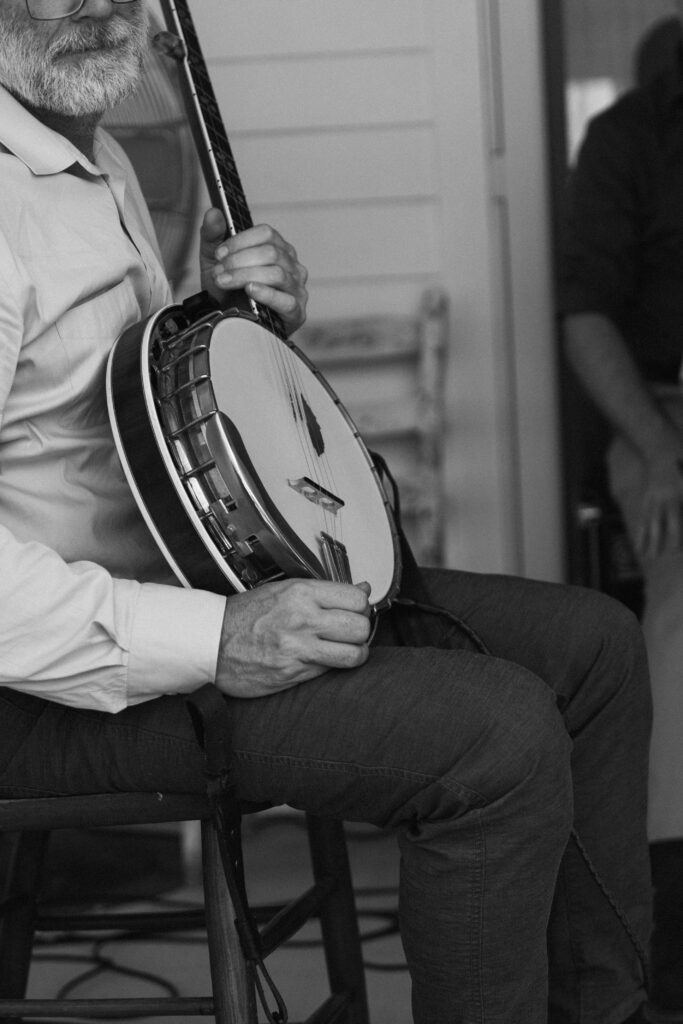 man holding banjo before a wedding ceremony