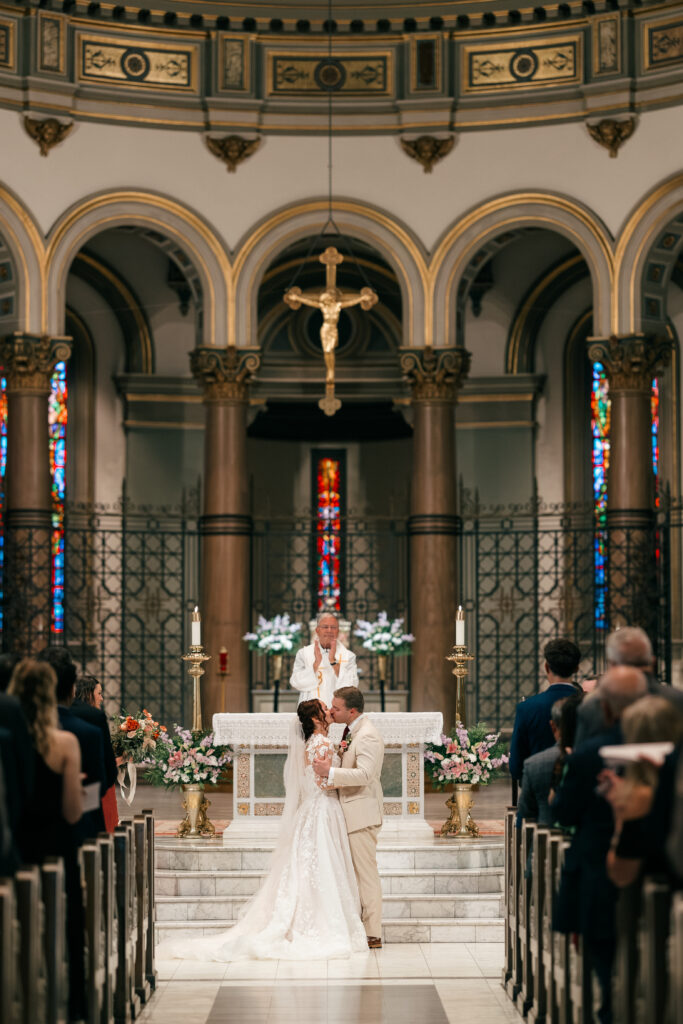 bride and groom first kiss at wedding ceremony