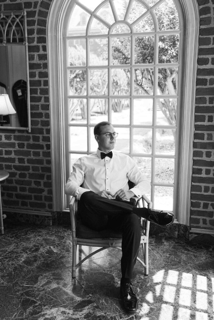 groom sitting in chair