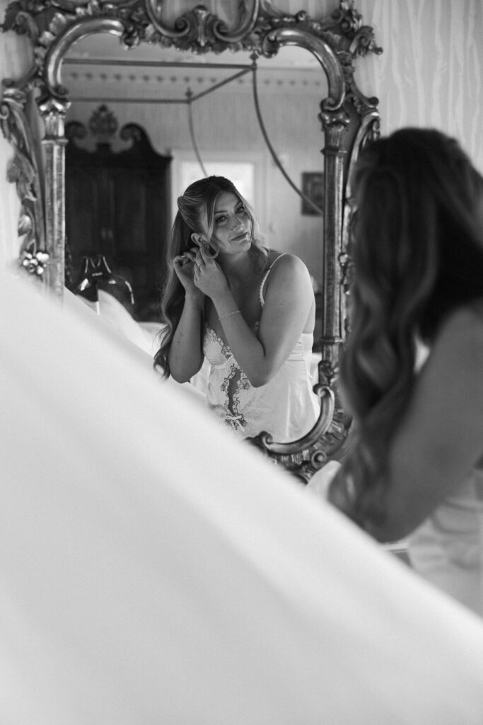 bride putting on jewelry